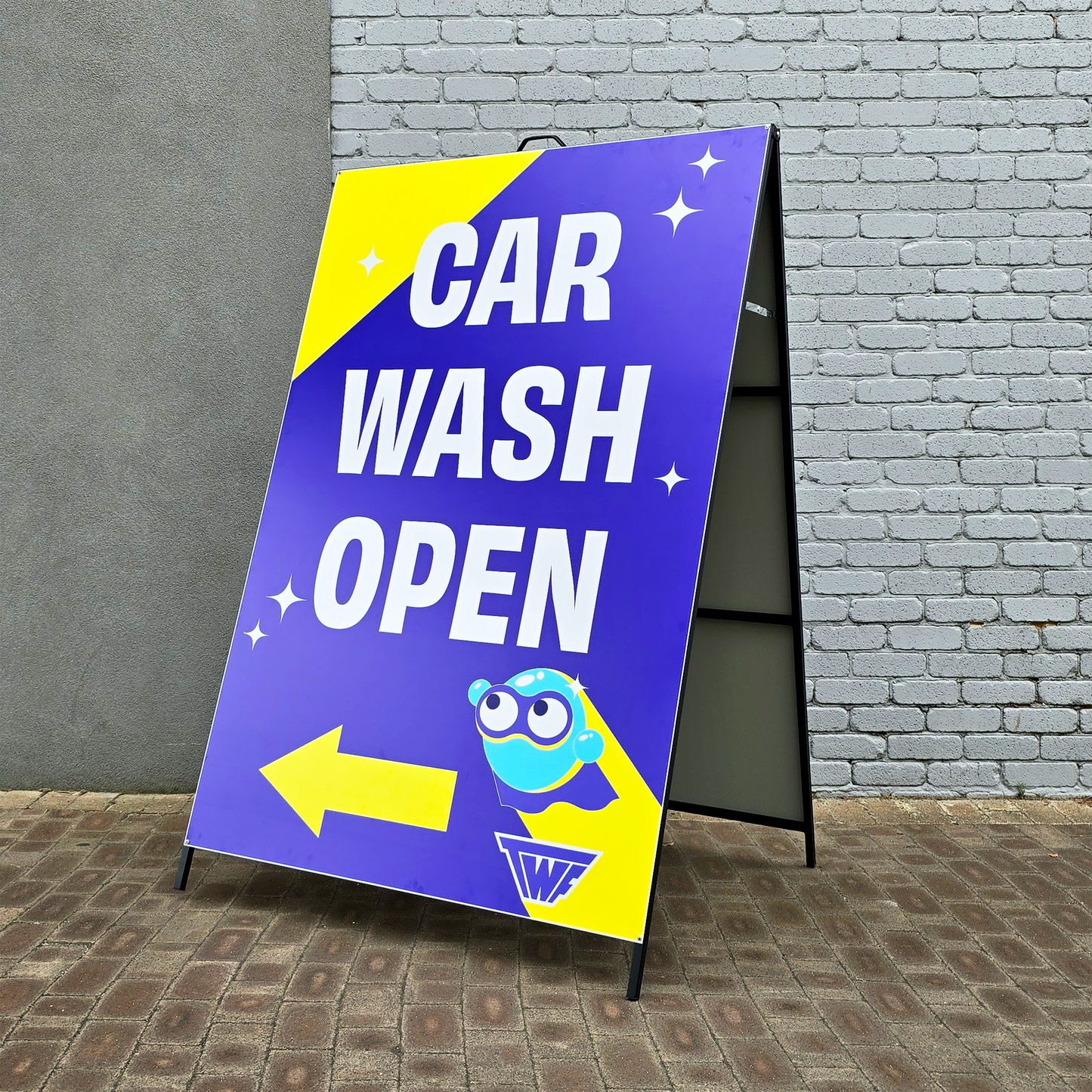 A large oversized A Frame, featuring the text 'Car Wash Open',A5 Saddle stitched booklets featuring a beauty clinic, custom designed and printed by Docuprint in Fremantle, Perth, Australia. Sitting on a white surface, with green plants next to it.