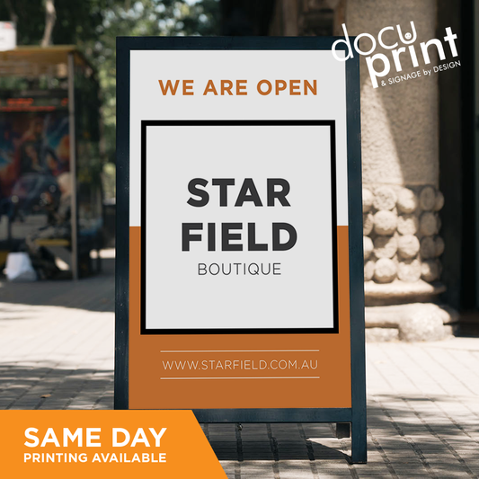 A frame with coflute inserts, saying we are open, custom designed and printed by Docuprint in Fremantle, Perth, Australia. Out the front of a business on the pavement.