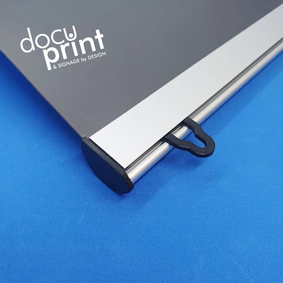 Poster clamps holding a promotional poster, designed and printed by Docuprint, displayed in Fremantle, Perth, Australia