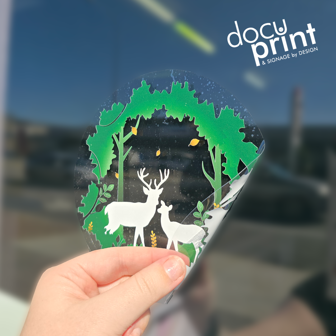 Clear static cling film featuring reindeer and green trees, custom designed and printed by Docuprint in Fremantle, Perth, Australia