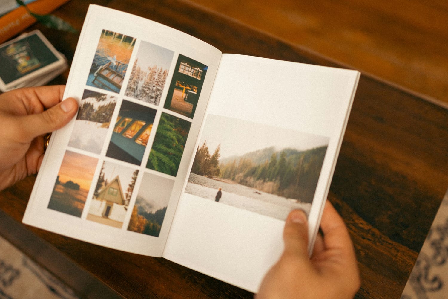 Person holding a photo album with scenic images, custom designed and printed by Docuprint in Fremantle, Perth, Australia