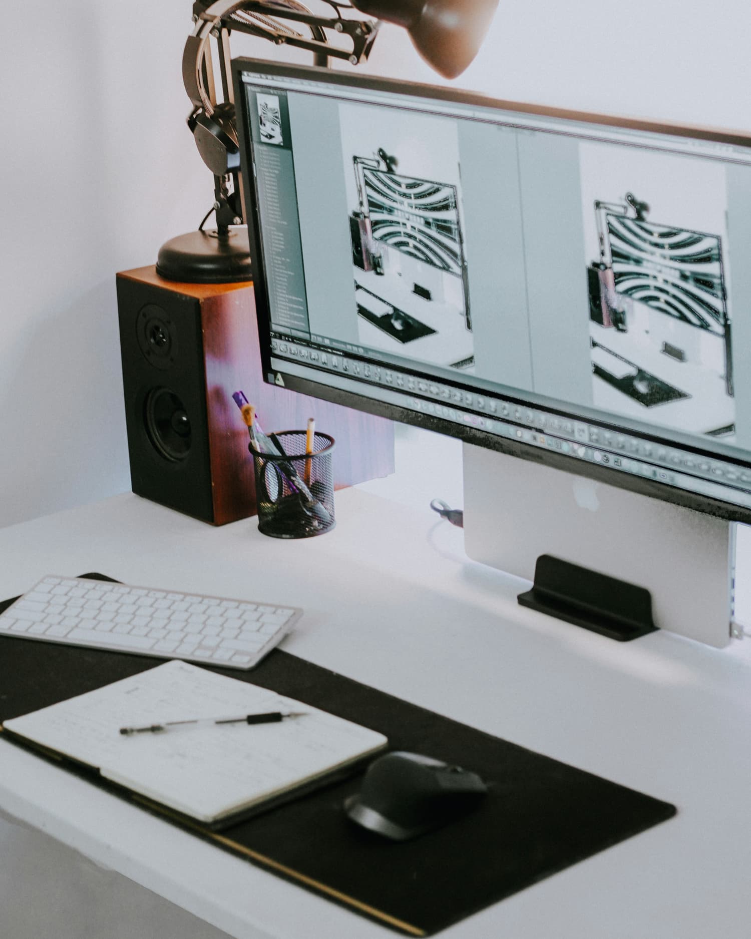 Desk setup with computer monitor, keyboard, mouse, and stationery on a white desk, showcasing custom design by Docuprint in Fremantle, Perth, Australia