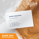 A white business card with black text and a company logo, placed on a wooden surface. The text includes a name, job title, company name, address, phone number, and email, custom designed and printed by Docuprint in Fremantle, Perth, Australia. 