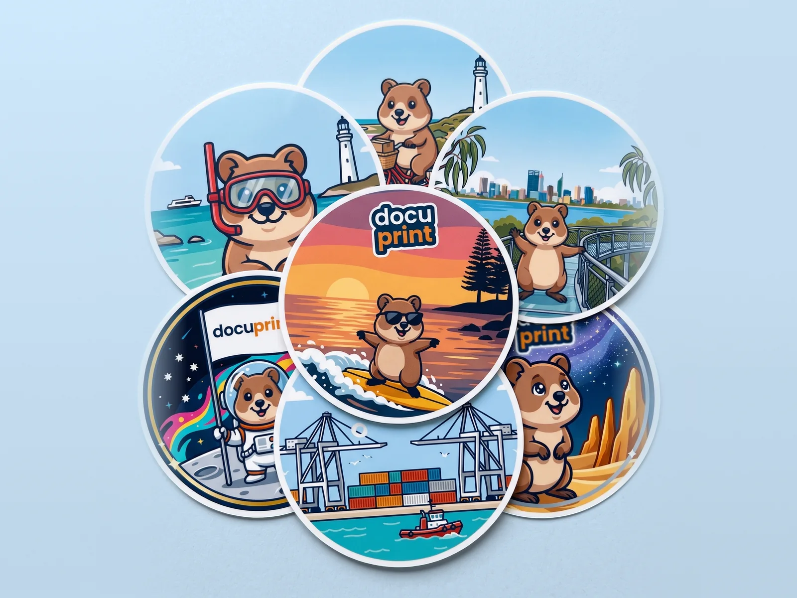 A pile of round Docuprint quokka stickers on a pale blue surface